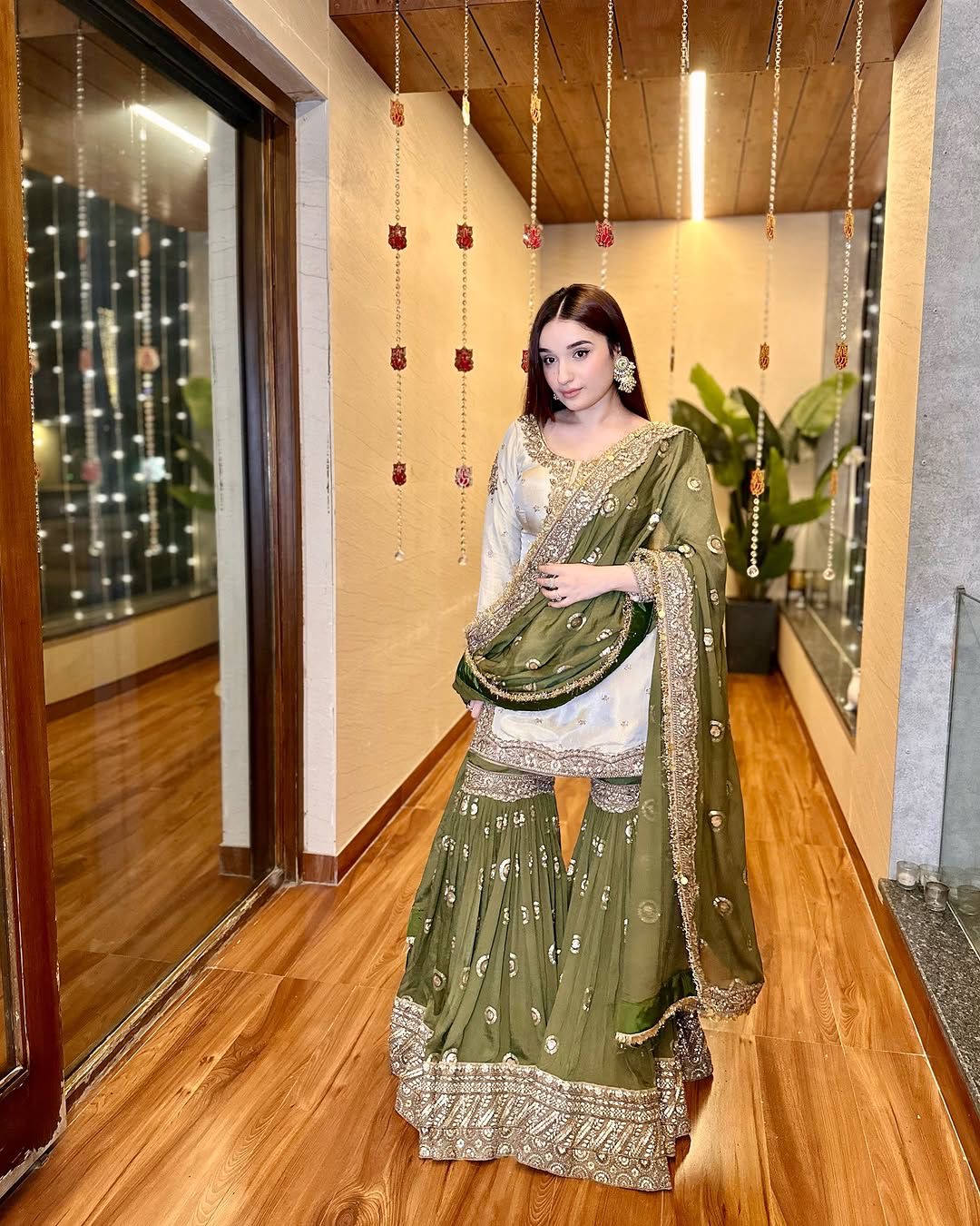 7f15e168-5f25-4041-8ca6-ded51b8389ee.jpeg Designer Olive Mirror Work Sharara Suit Set with Golden Kurti & Net Dupatta – Ethnic Evening Wear for Women - Image 1